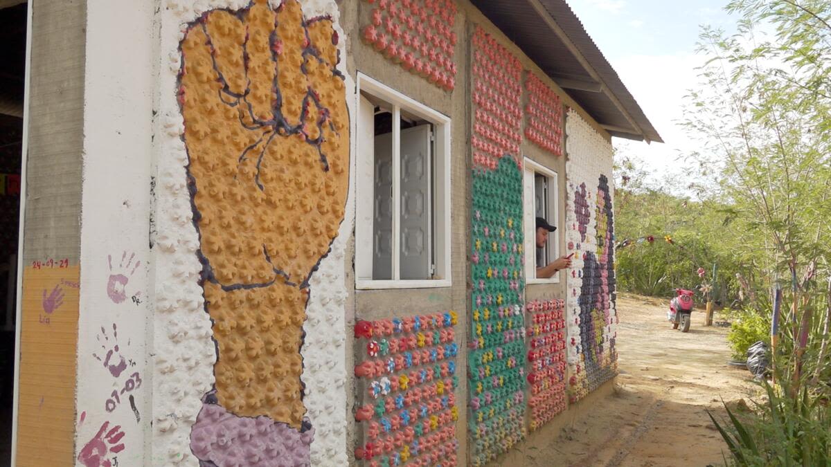 Close ups of a house called 'Chica Street' that Oriana helped to build out of recycled plastic bottles in Norte de Santander, Colombia.