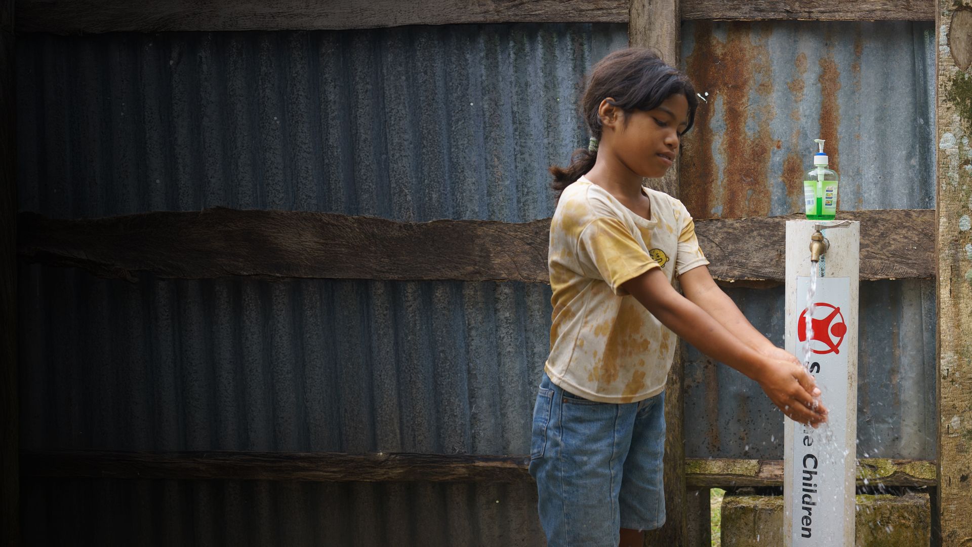 Chouchou*, 10, and Patience by the river in Kasai, DRC.