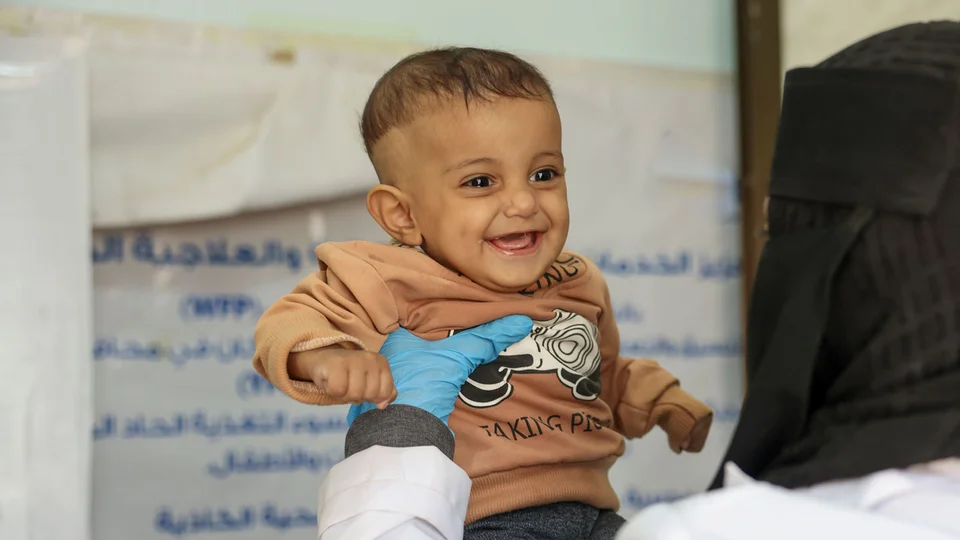 Baby Murad met een verpleegster van Save the Children