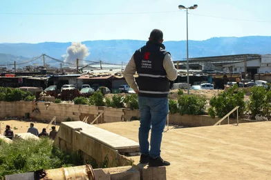Save the Children staff watching smoke after a strike in Beirut