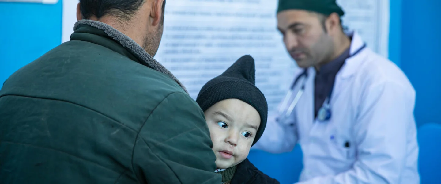 Rasool* with his son Yama* for a check-up during their visit to Dr. Hanif*