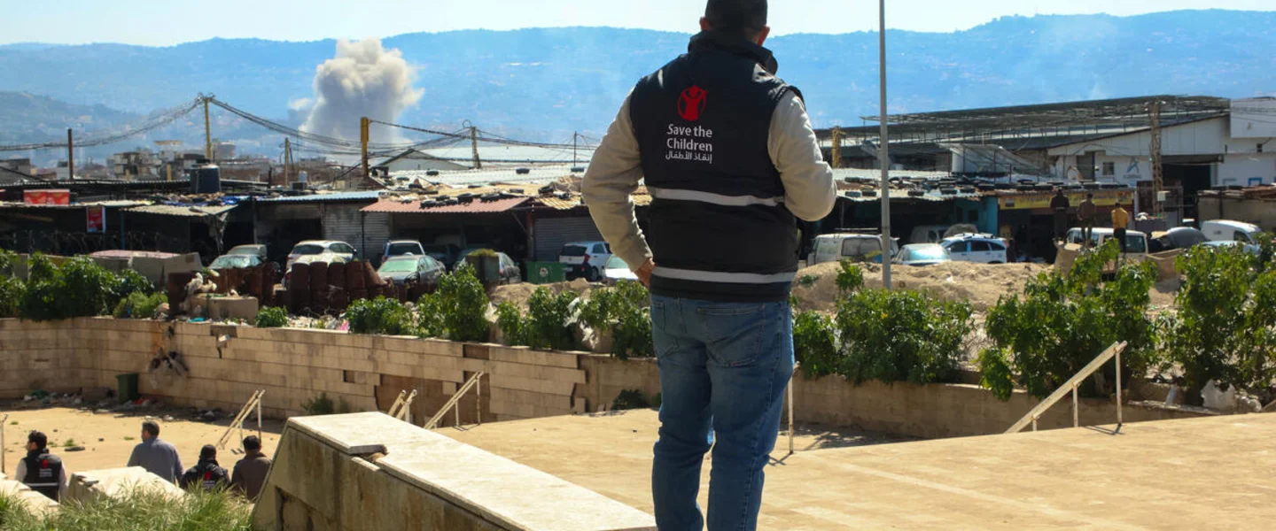 Save the Children staff watching smoke after a strike in Beirut